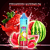 "Colorful vape pen with a cartoon monkey design, surrounded by splashing strawberries and watermelon slices, with 'Strawberry Watermelon' text at the top."