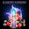 A vape device with a cartoon monkey graphic labeled "RandM Tornado" surrounded by blueberries, raspberries, and splashes of liquid, with the text "Blueberry Raspberry" at the top.