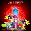 An image of a "Randy Tornado" vape device with a cartoon monkey wearing a red cowboy hat on the label, surrounded by mixed berries, including raspberries, blackberries, blueberries, and blackcurrants, set against a vibrant red background with splashes of juice. The text "MIXED BERRIES" appears at the top.